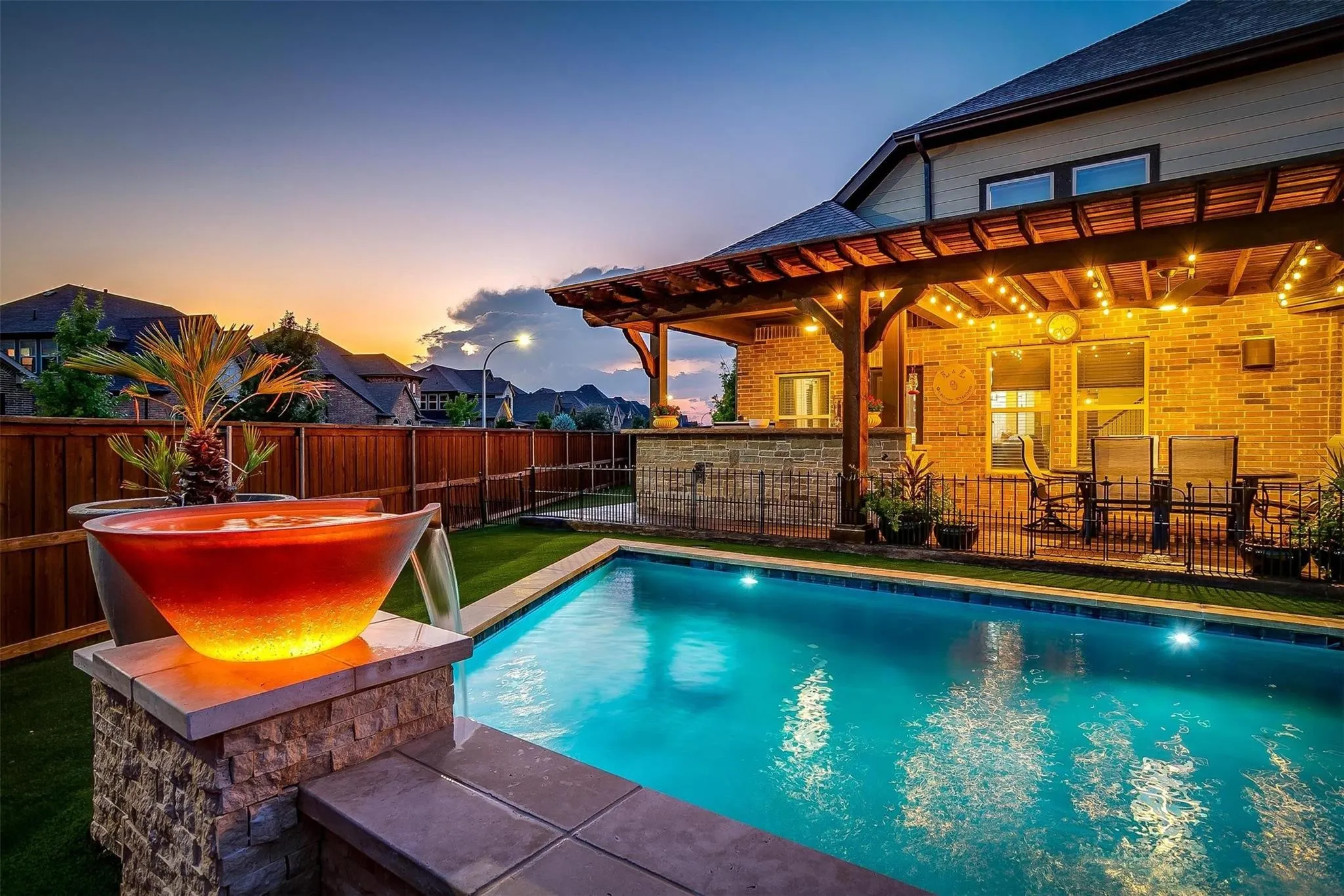 Beautiful pool design with fire feature at sunset